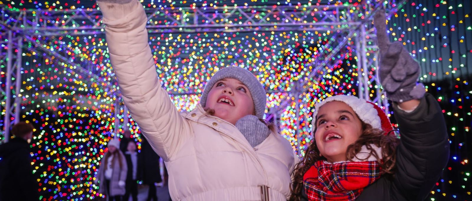 Two children look in awe at twinkling lights at Marwell Zoo